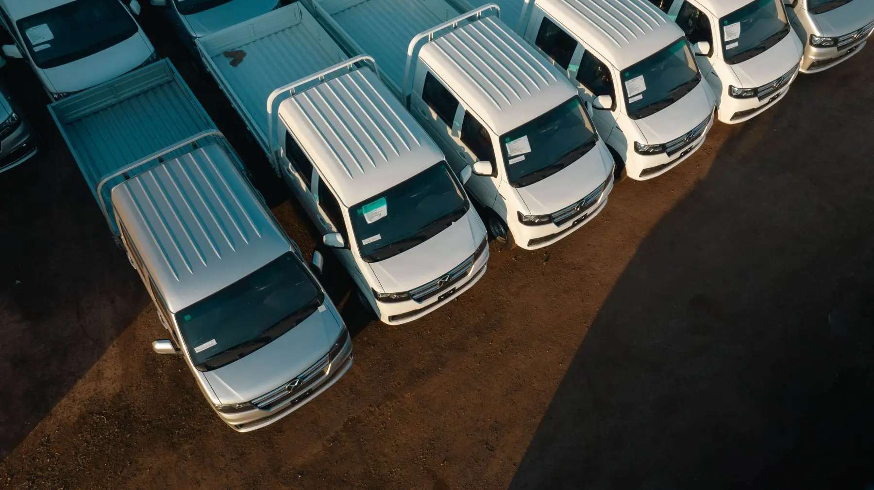 Service trucks lined up at a shop