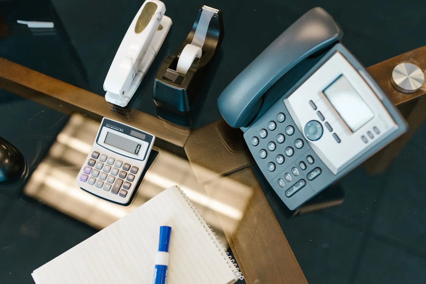 Calculator and desk phone on a work surface